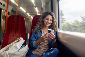 Woman on a train looking at her phone
