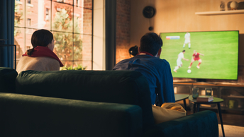 Fans watching live sports on a TV