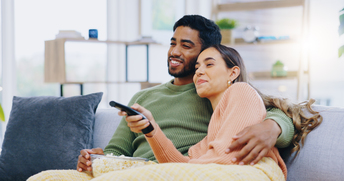 Couple watching television together